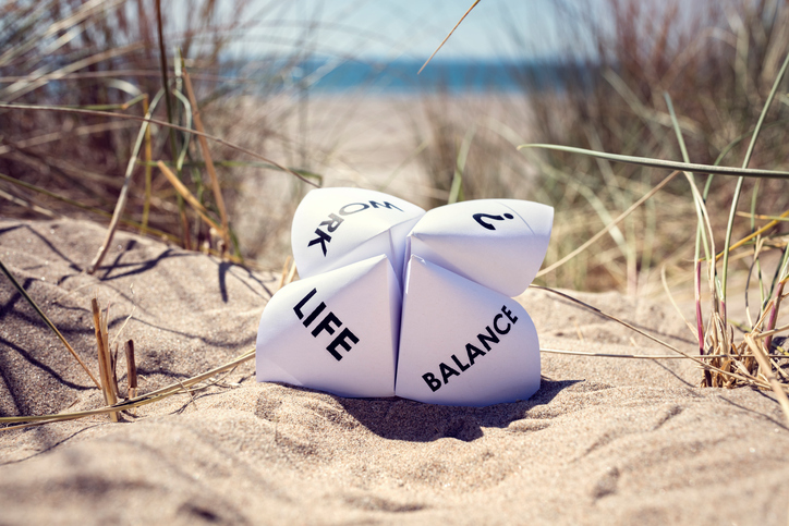 Origami fortune teller on vacation at the beach concept for work-life balance choices