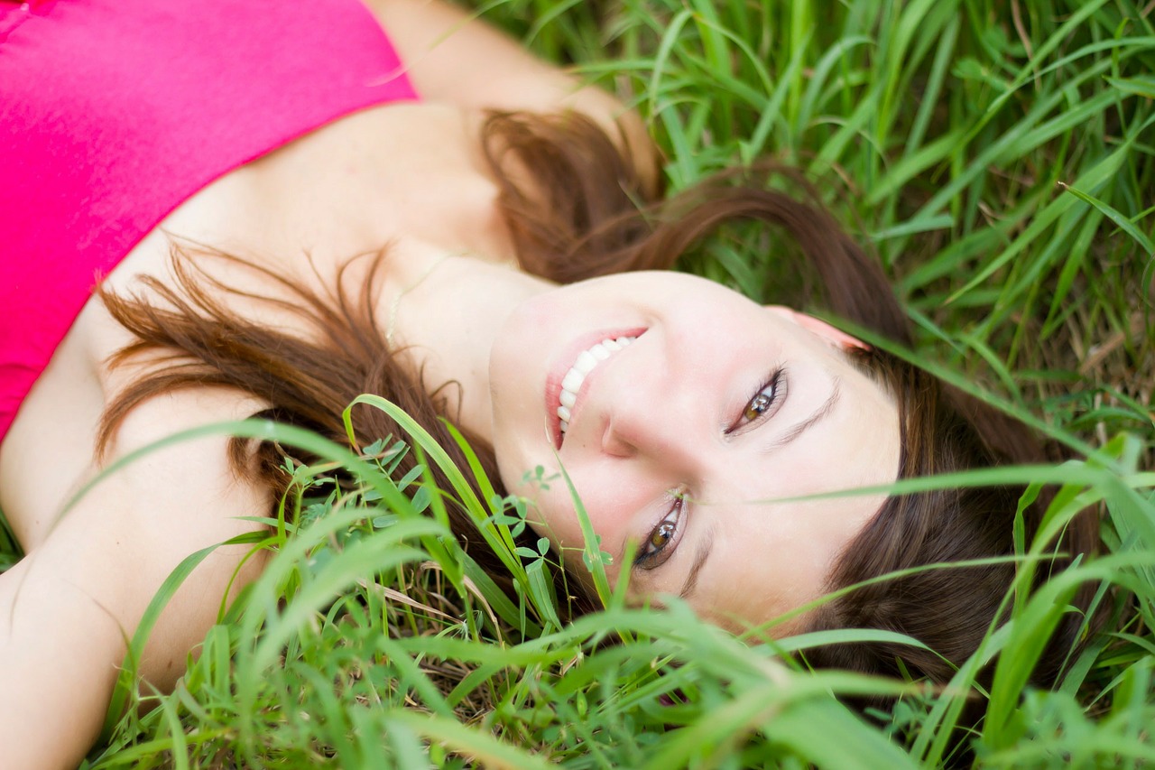 woman lying in grass smiling