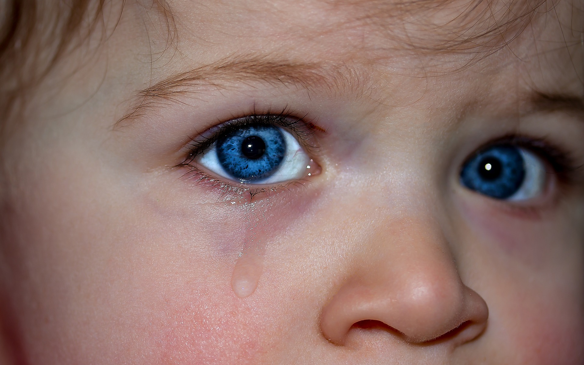 Teary-blue-eyed child.