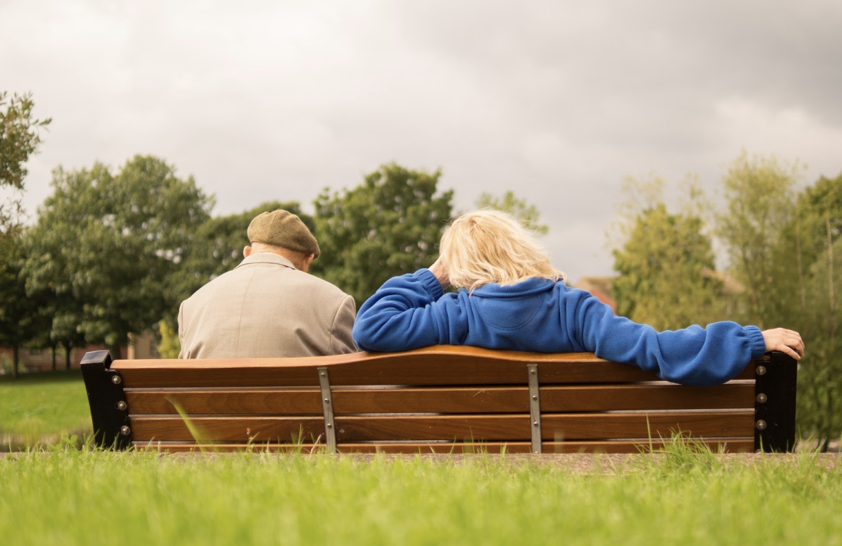 retired couple sitting on bench