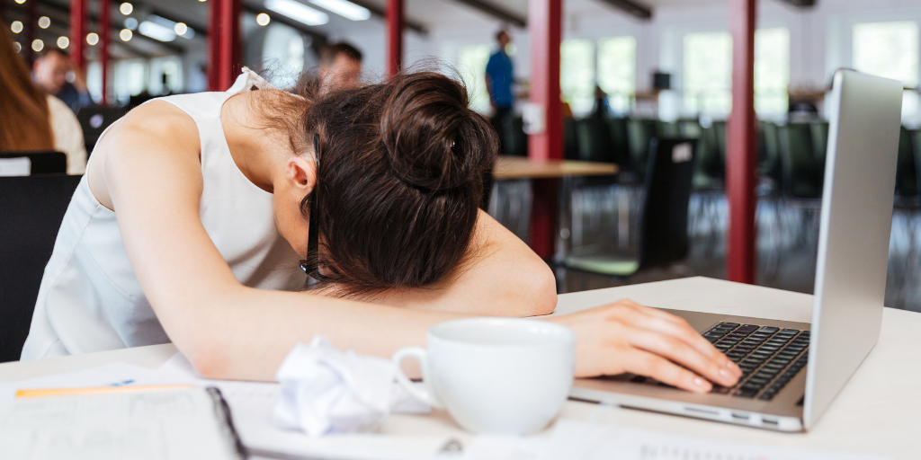 woman falling asleep at her desk