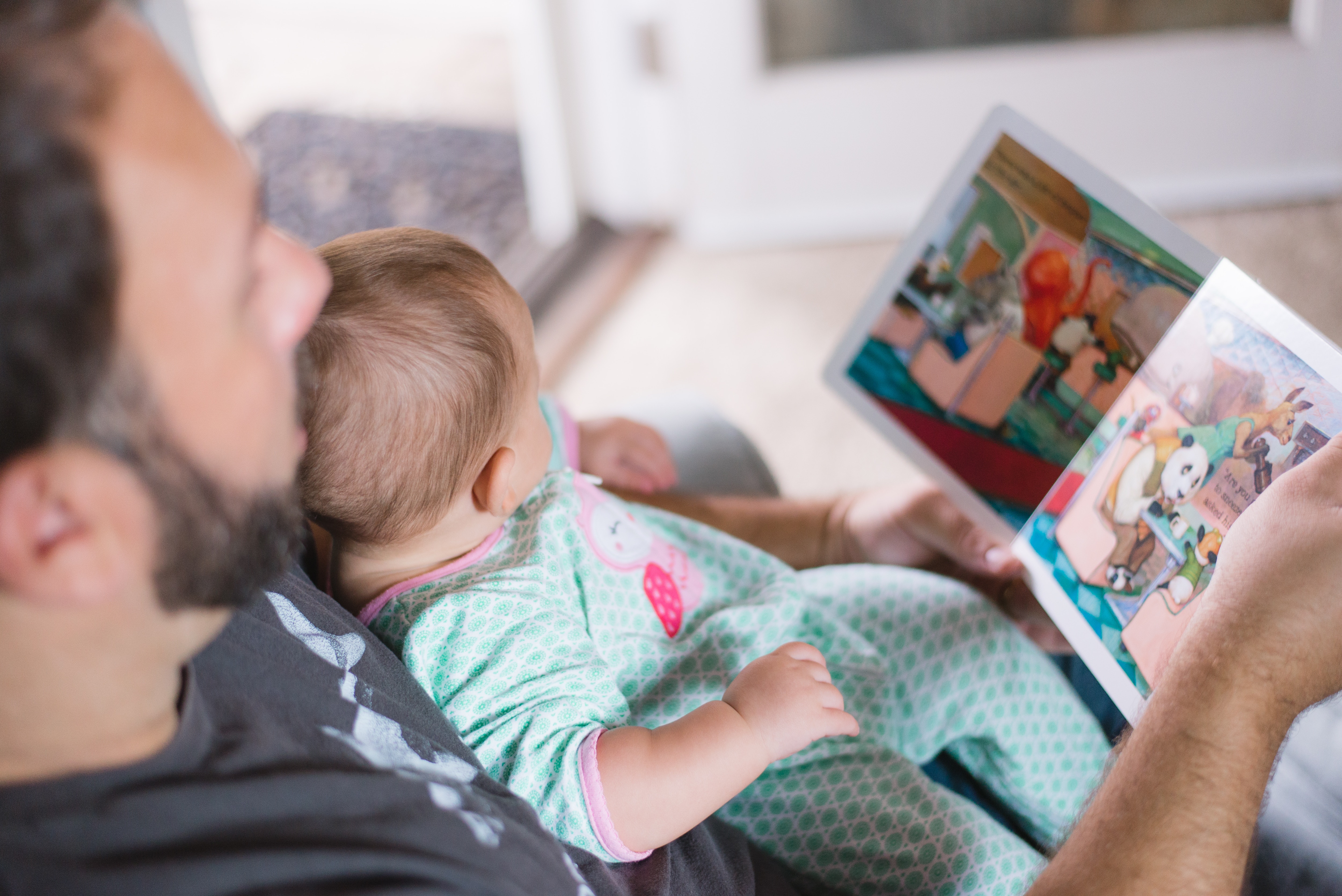 Father reading story to baby