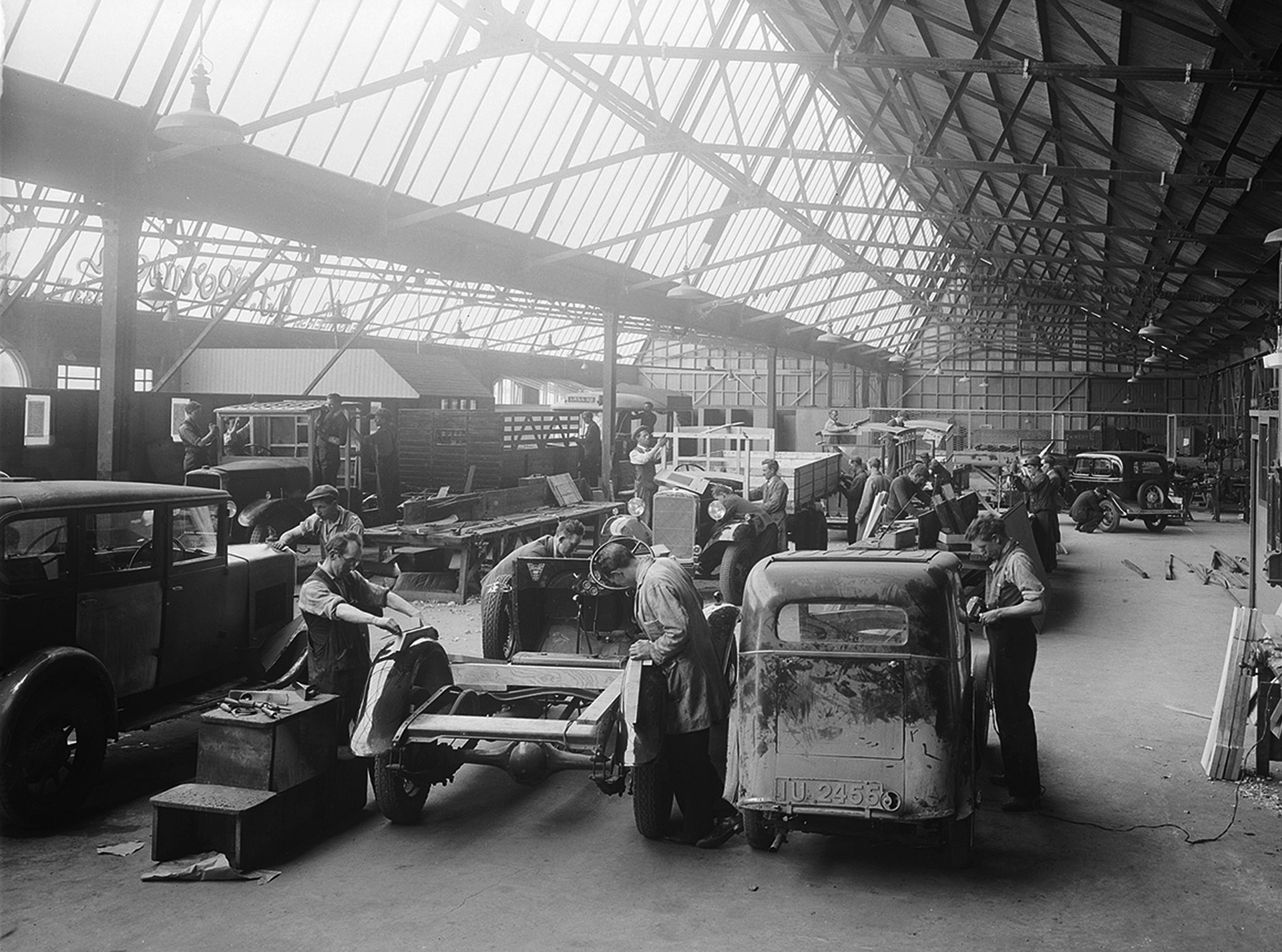 Car production assembly line in the vintage era