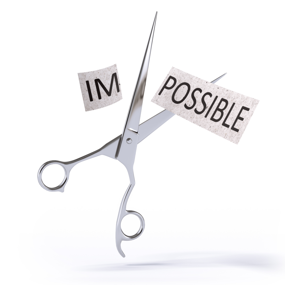 a pair of scissors cutting the word impossible taking out the IM, separating possible