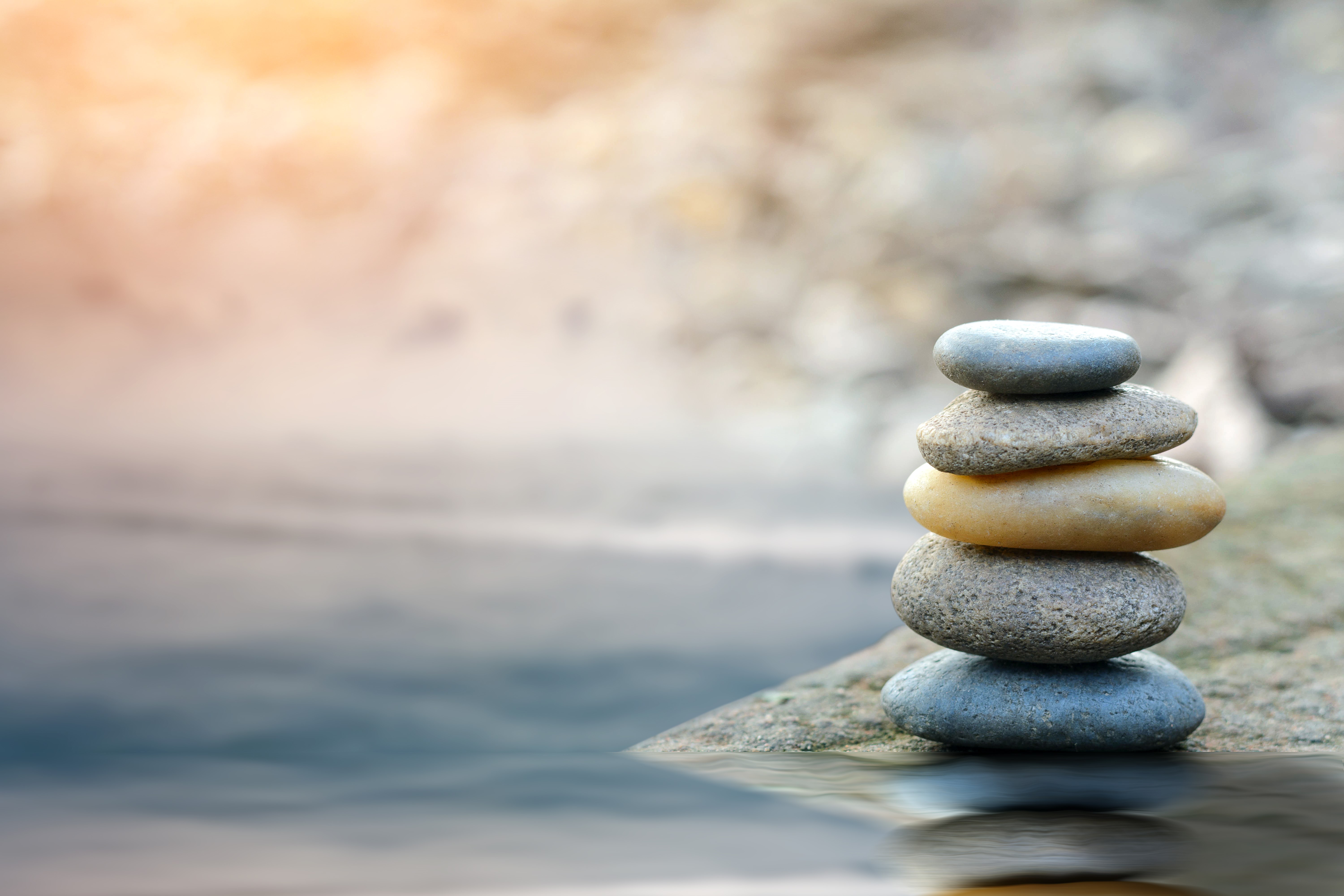 Stacked rocks represent ways to reduce stress in your life right now