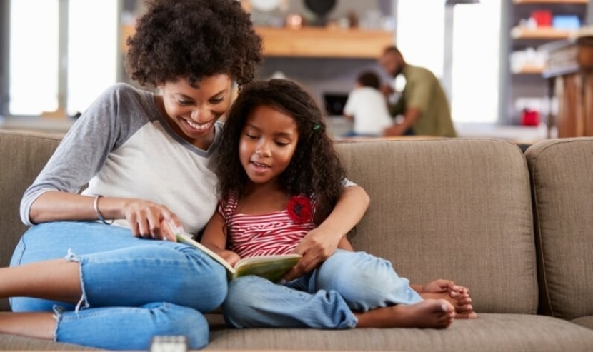 mom reading a book to child