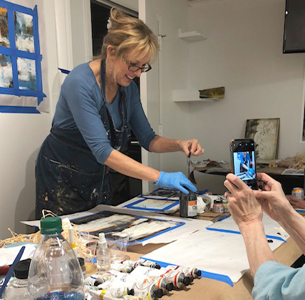 This is a photo of Rachael McCampbell demonstrating charcoal powder in a Cold Wax Medium Painting workshop in VA. 
