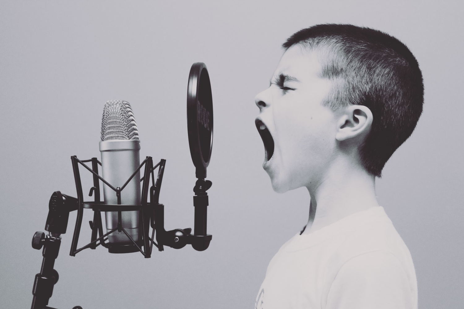 child screaming into a microphone