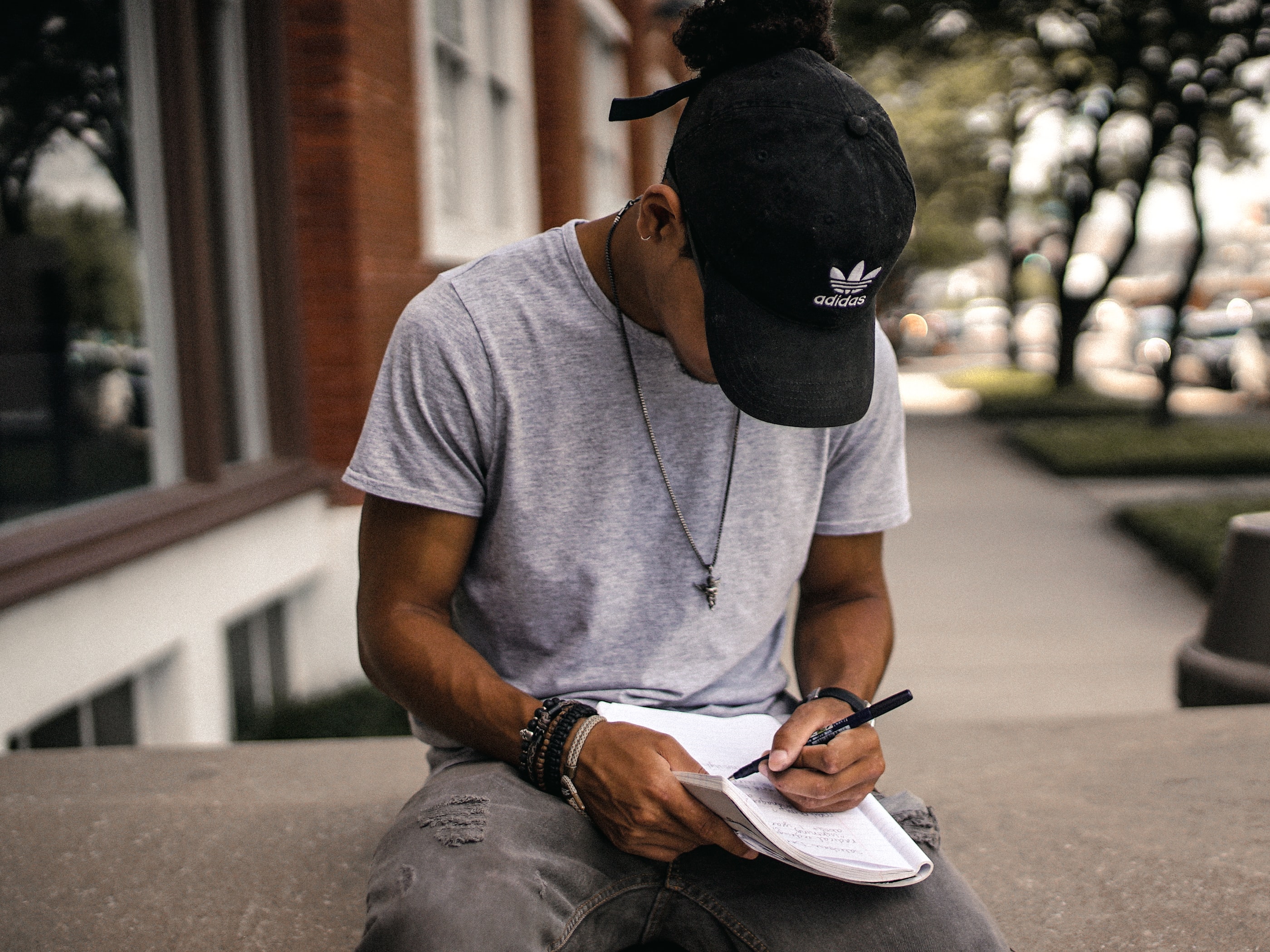 man writing in notebook