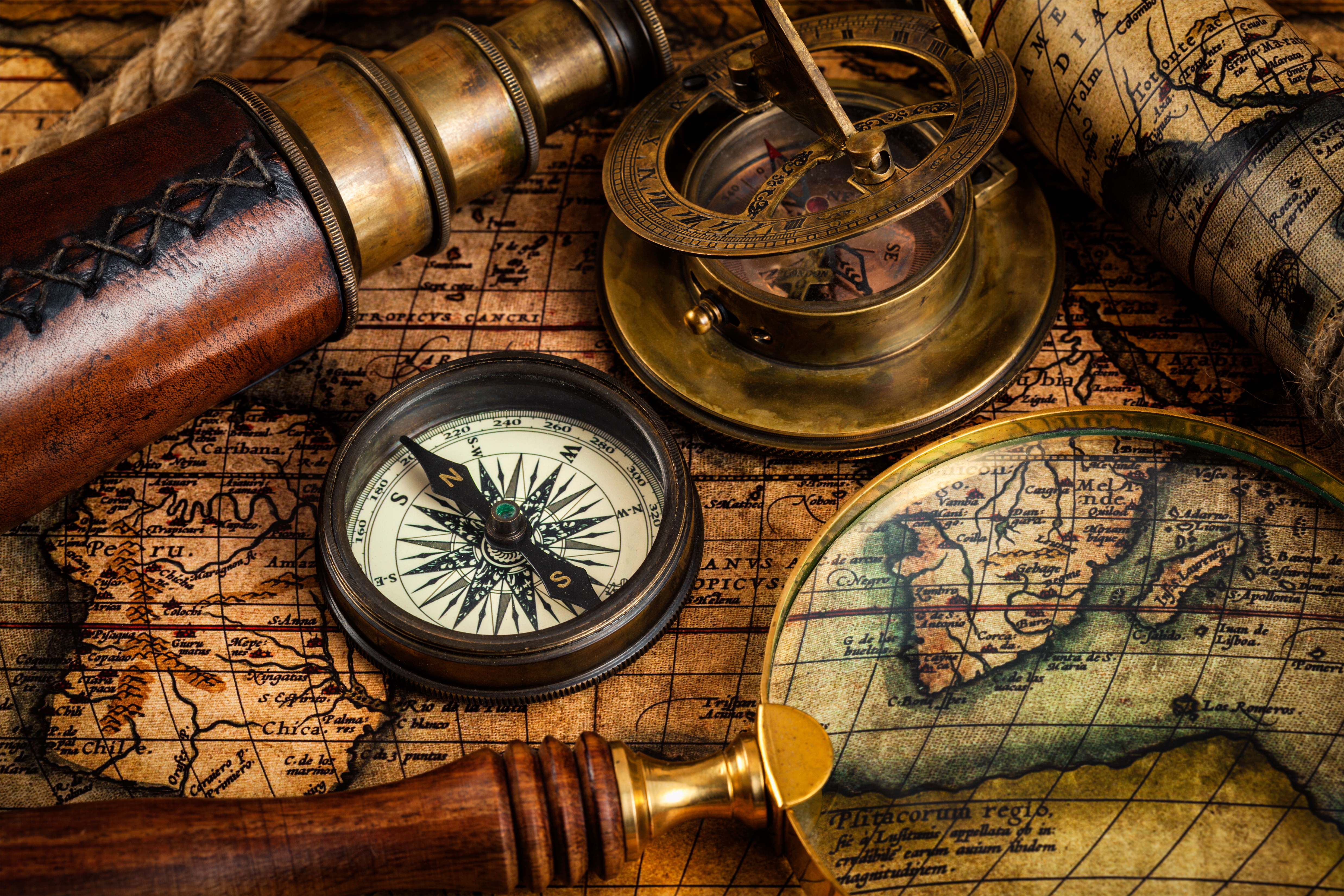 Old vintage compass and travel instruments on ancient map (iStock)