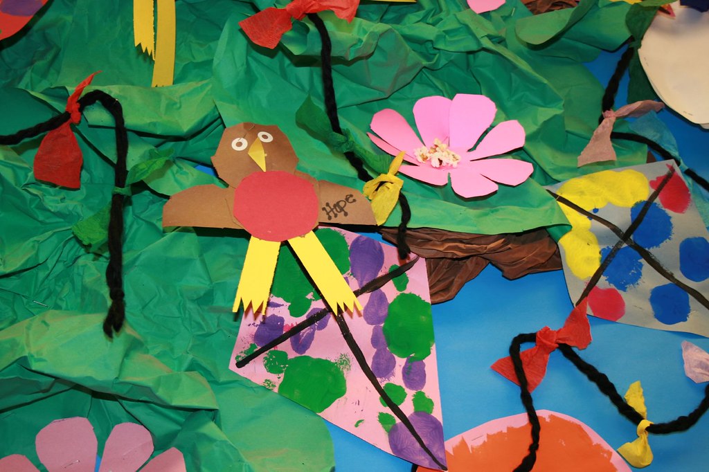 A child's collage of birds and flowers.