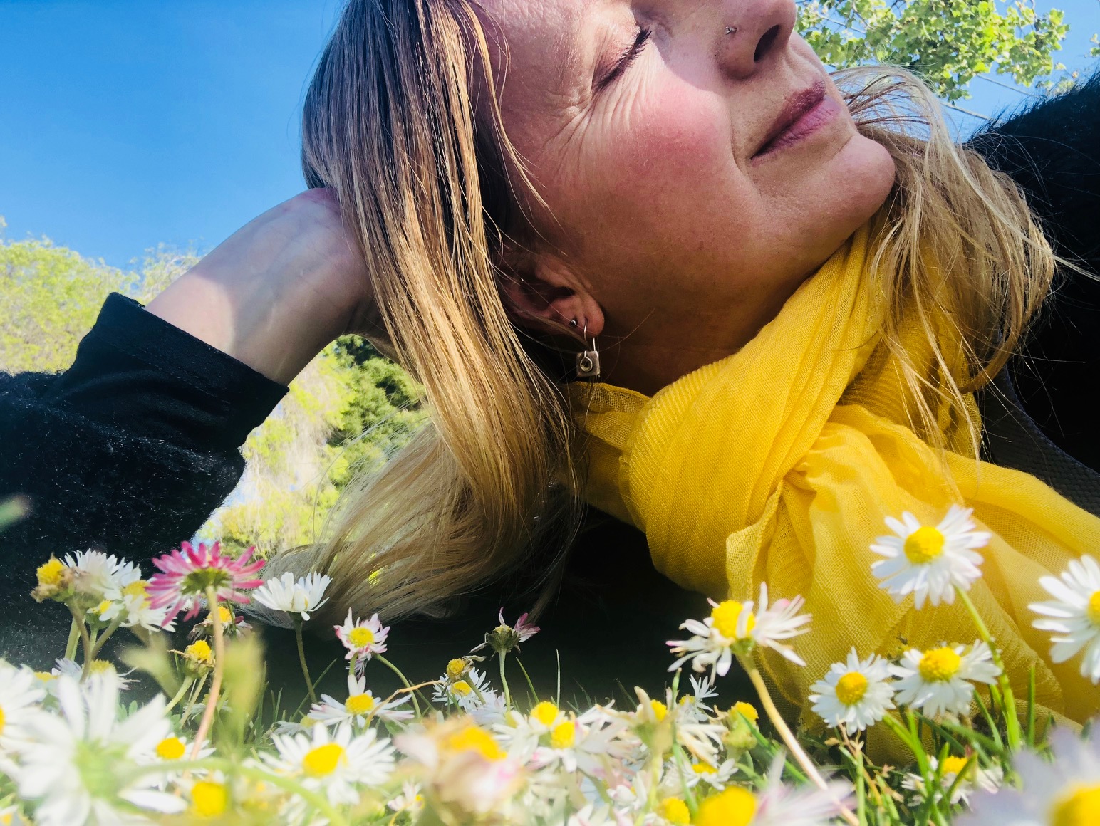 Peaceful woman lying in flowers