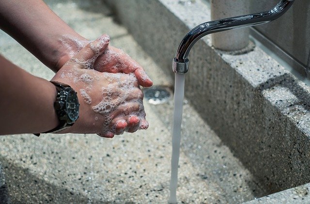 hands washing under running tap water