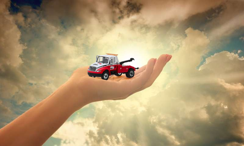AAA truck held in the hand of God