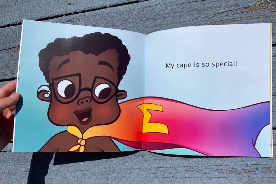 A book with a child hero wearing glasses and a hearing aide