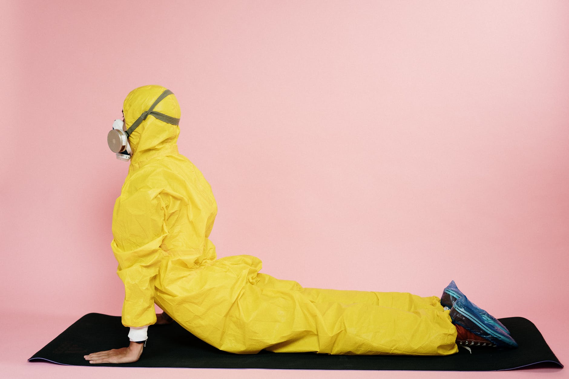 man in yellow protective suit stretching