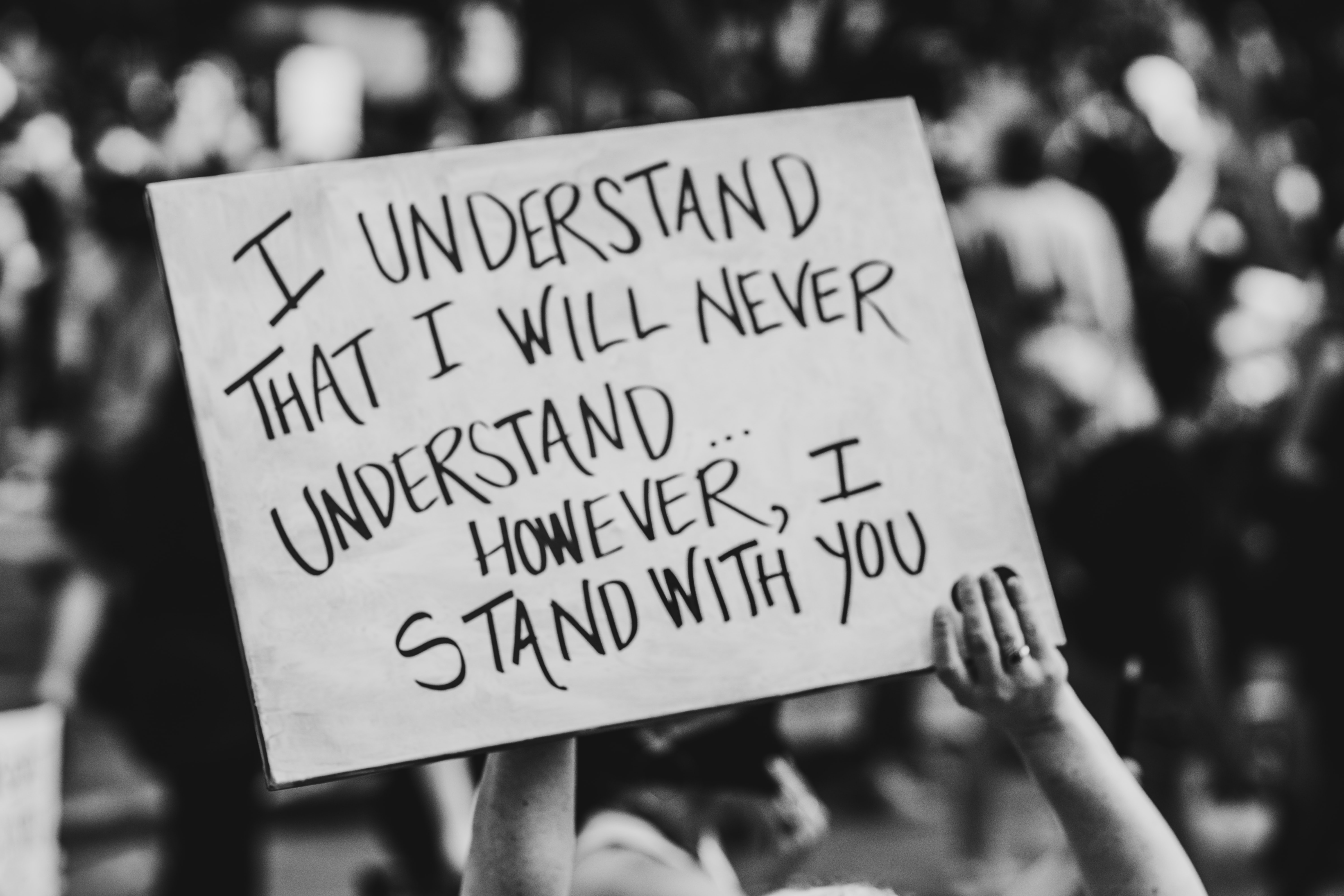 A placard that reads "I understand That I will never understand... However, I will stand with you"