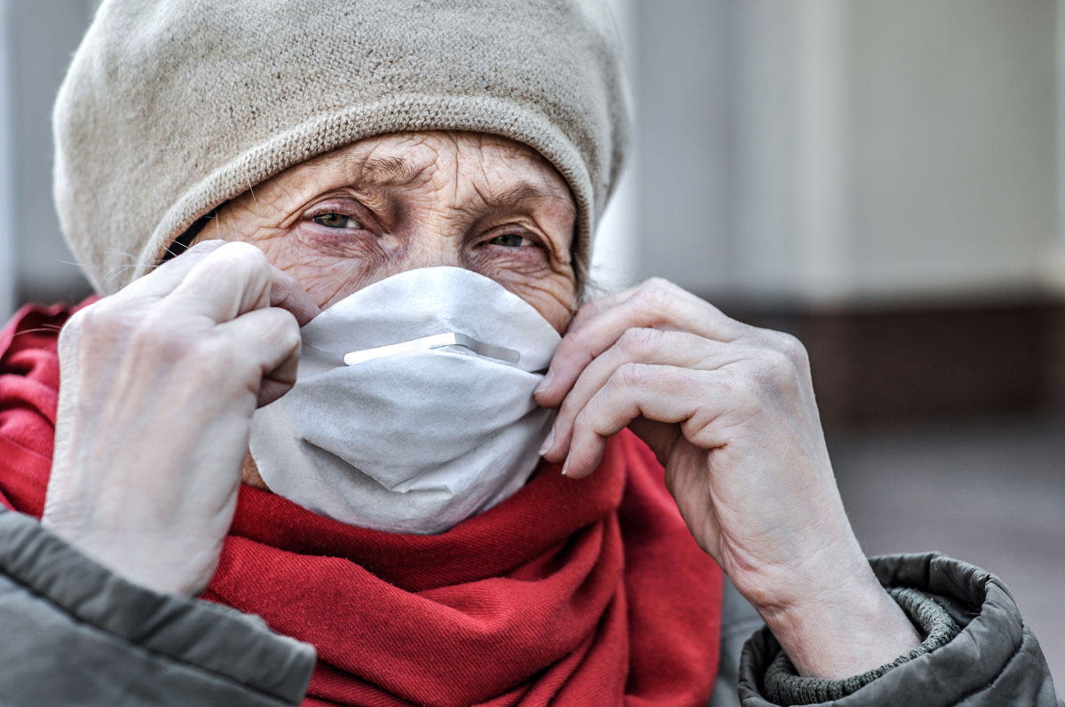 Elderly woman wearing face-mask.