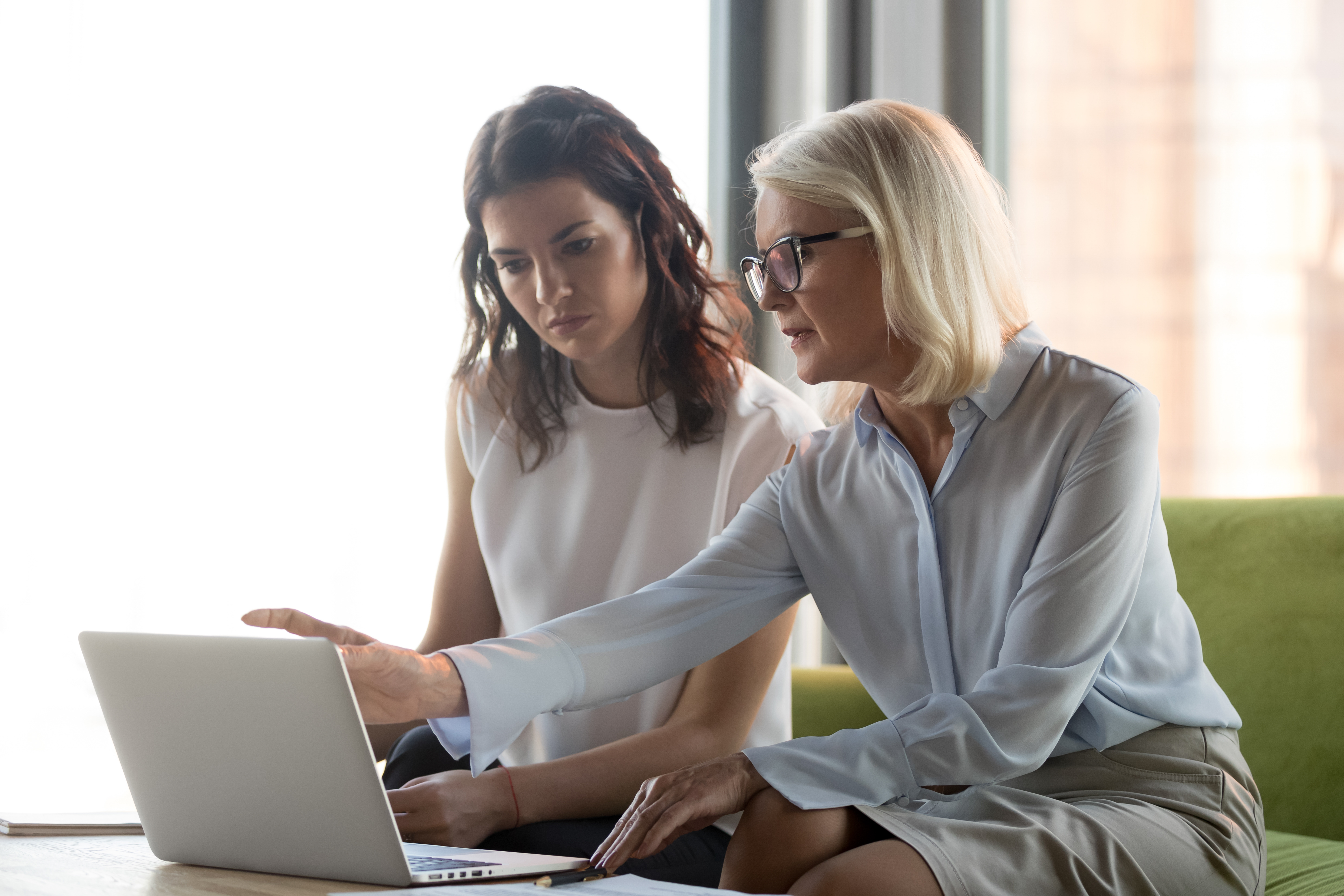 Middle aged woman mentoring young woman (Adobe stock image)