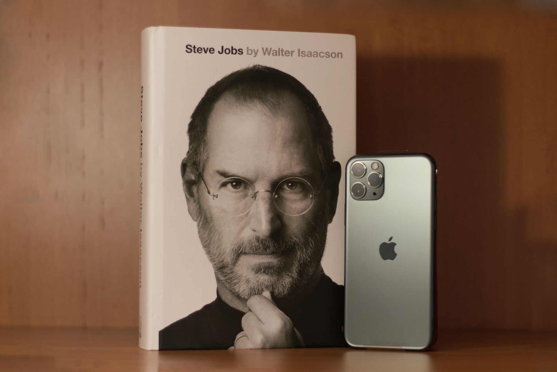 Steve jobs photo in a book cover and iPhone