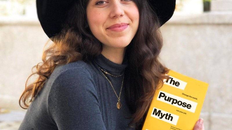 Charlotte Cramer, author of The Purpose Myth, holds book