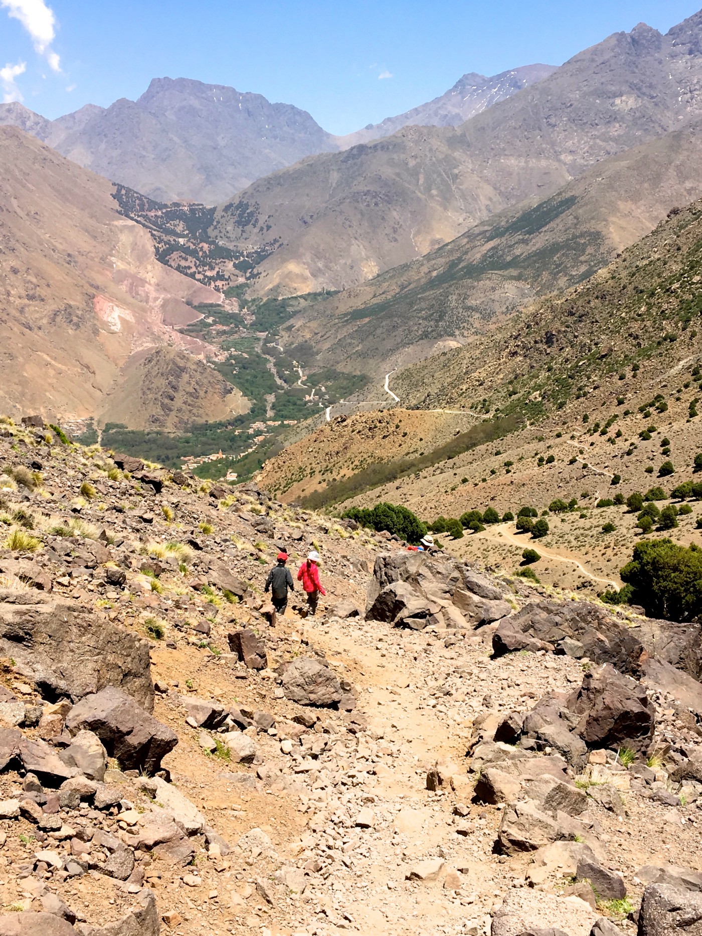Two children walking down major slope in Atlas Mountains in Morocco. 