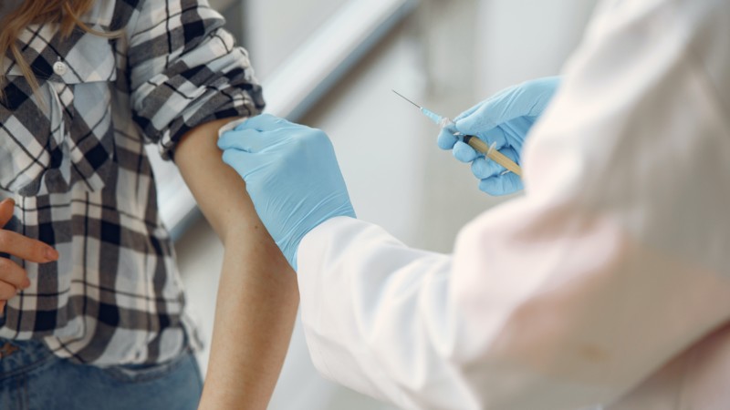 an image of a person getting a shot or vaccine, representing the COVID-19 vaccine