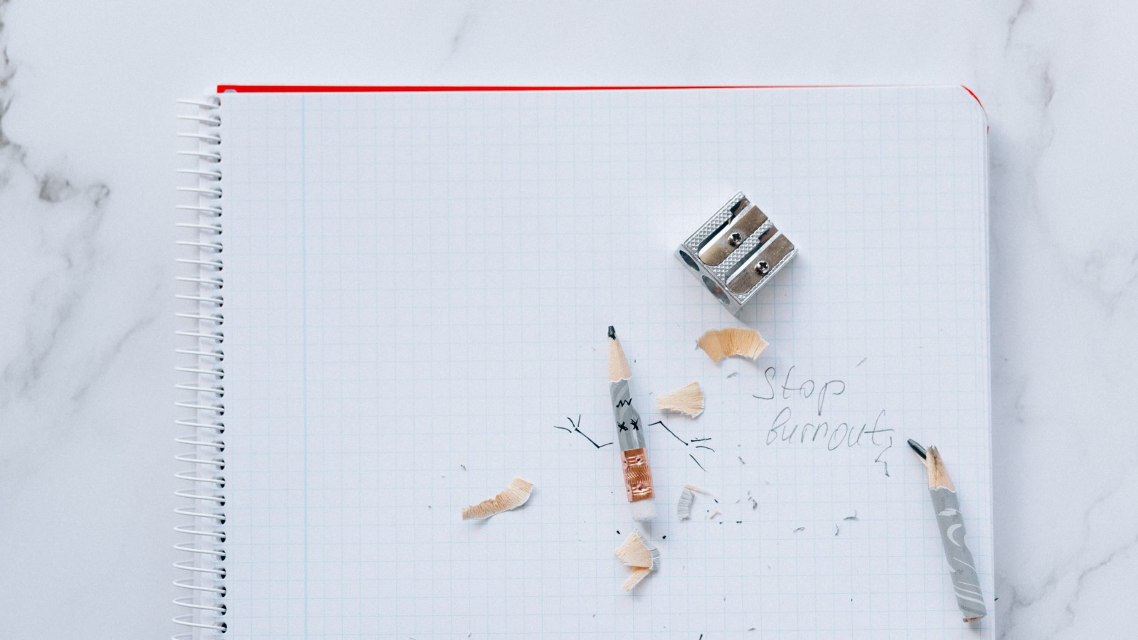 Pencil and shavings with pencil sharpener on a journal page with the note, "Stop Burnout"