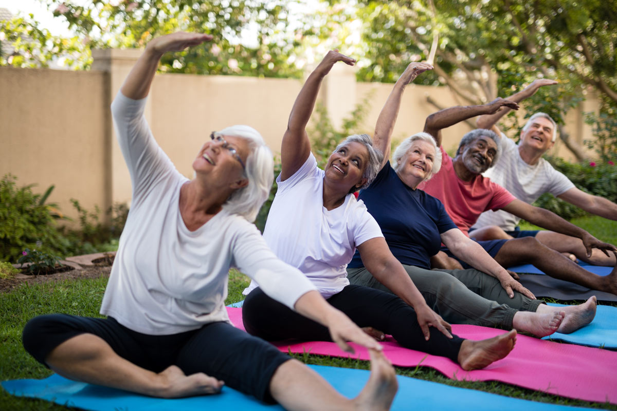 Active-elders-outside-doing-yoga-together-and-aging-well.