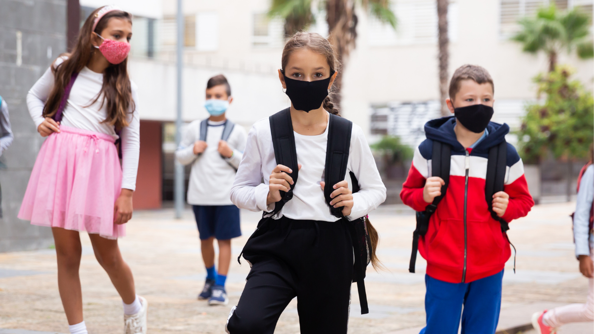 Image of kids heading to school with masks on faces