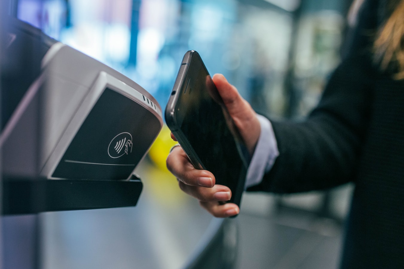 A photo of someone using a mobile-based payment system, highlighting the ease and inclusiveness of fintech solutions.
