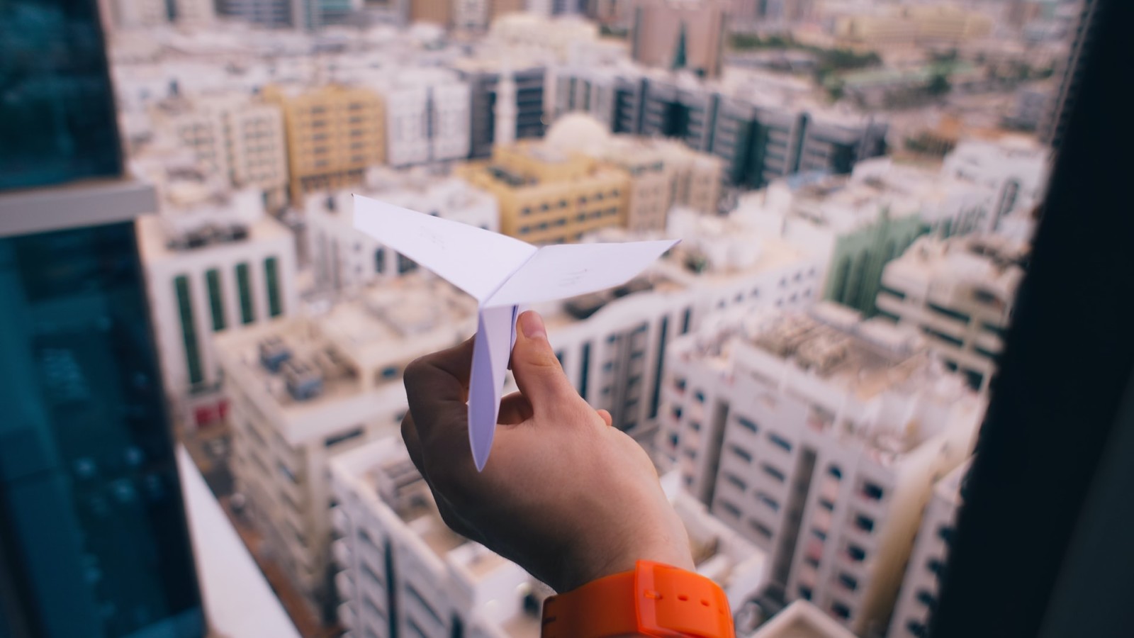 person holding paper airplane