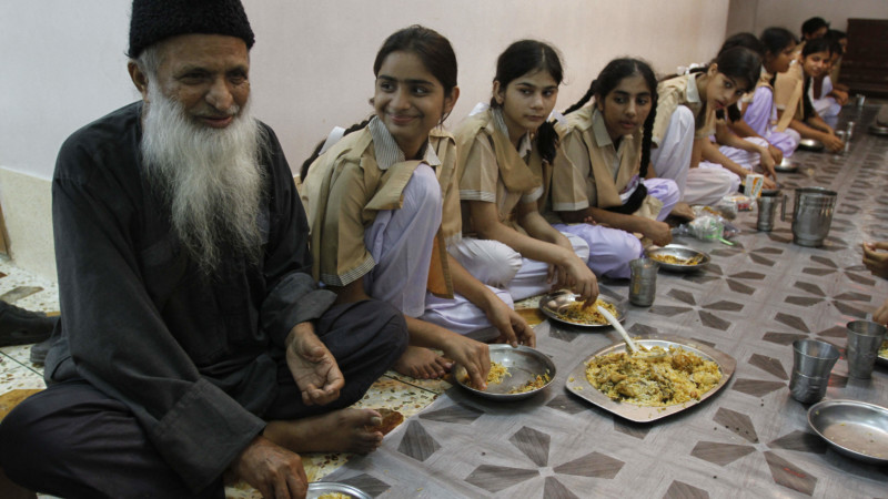 Abdul Sattar Edhi sharing meal with kids in one of the charity houses