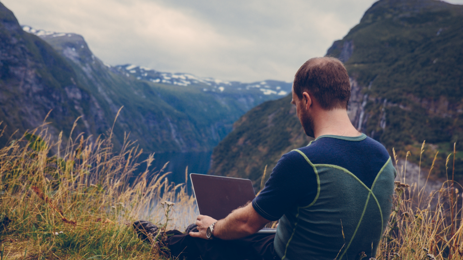 A guy working remotely in nature