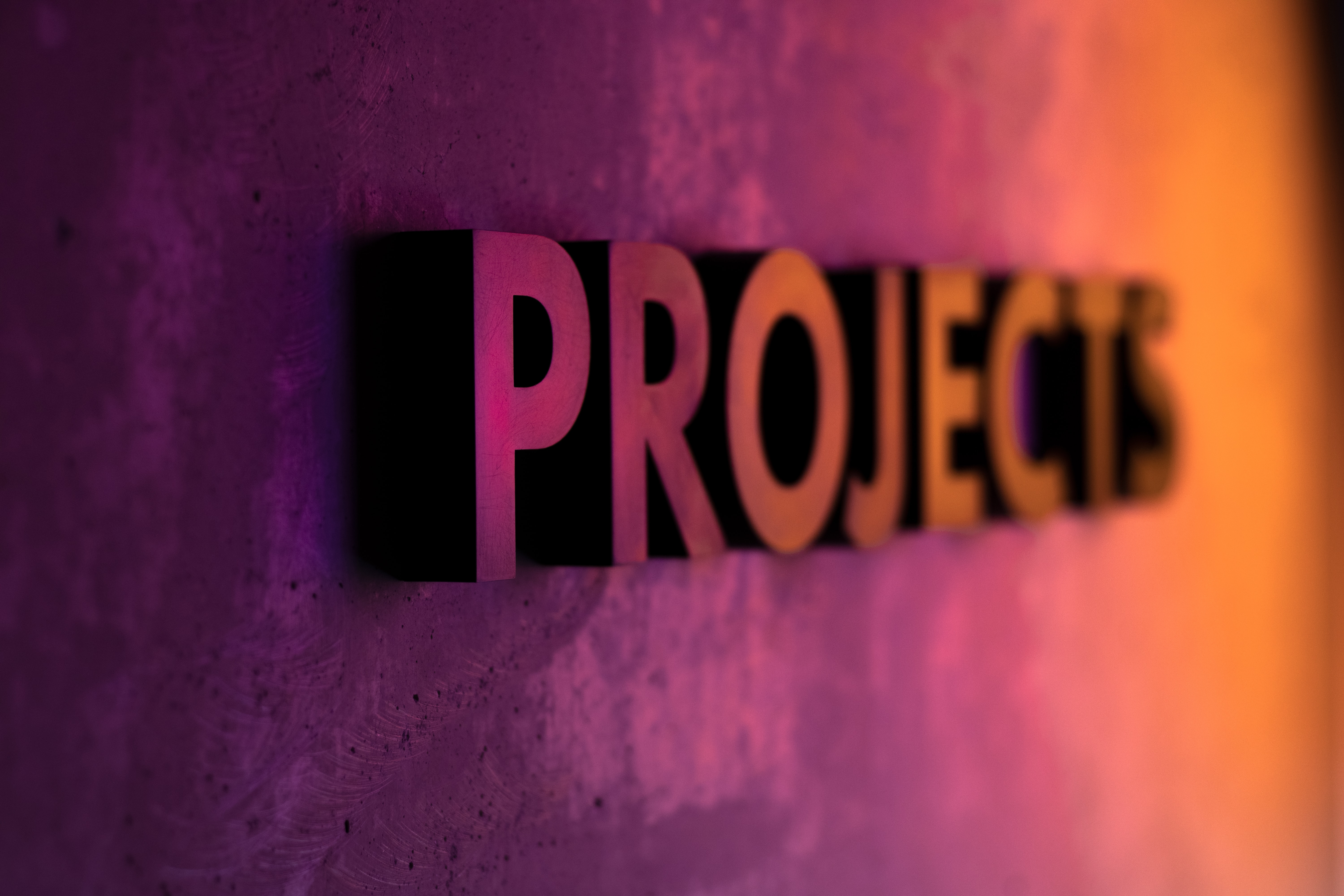 the word "projects" appears in 3D from a wall