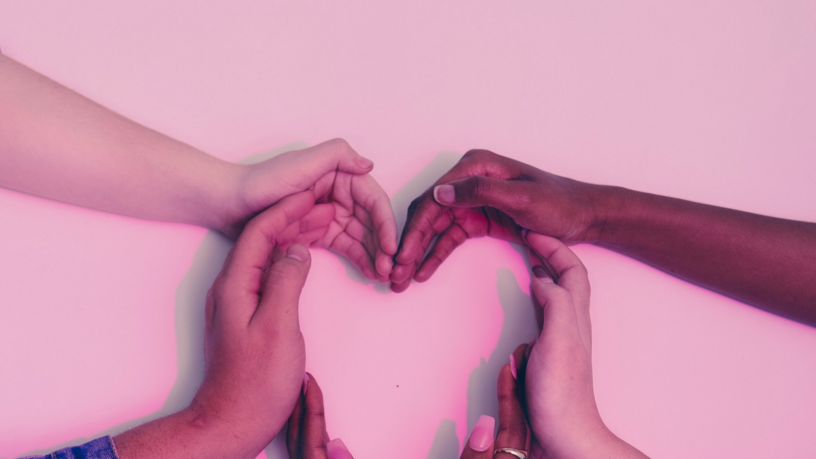 photo of hands of multiple skin tones placed in shape of heart. Photo on Dr. James Goydos post about skin cancer prevention.