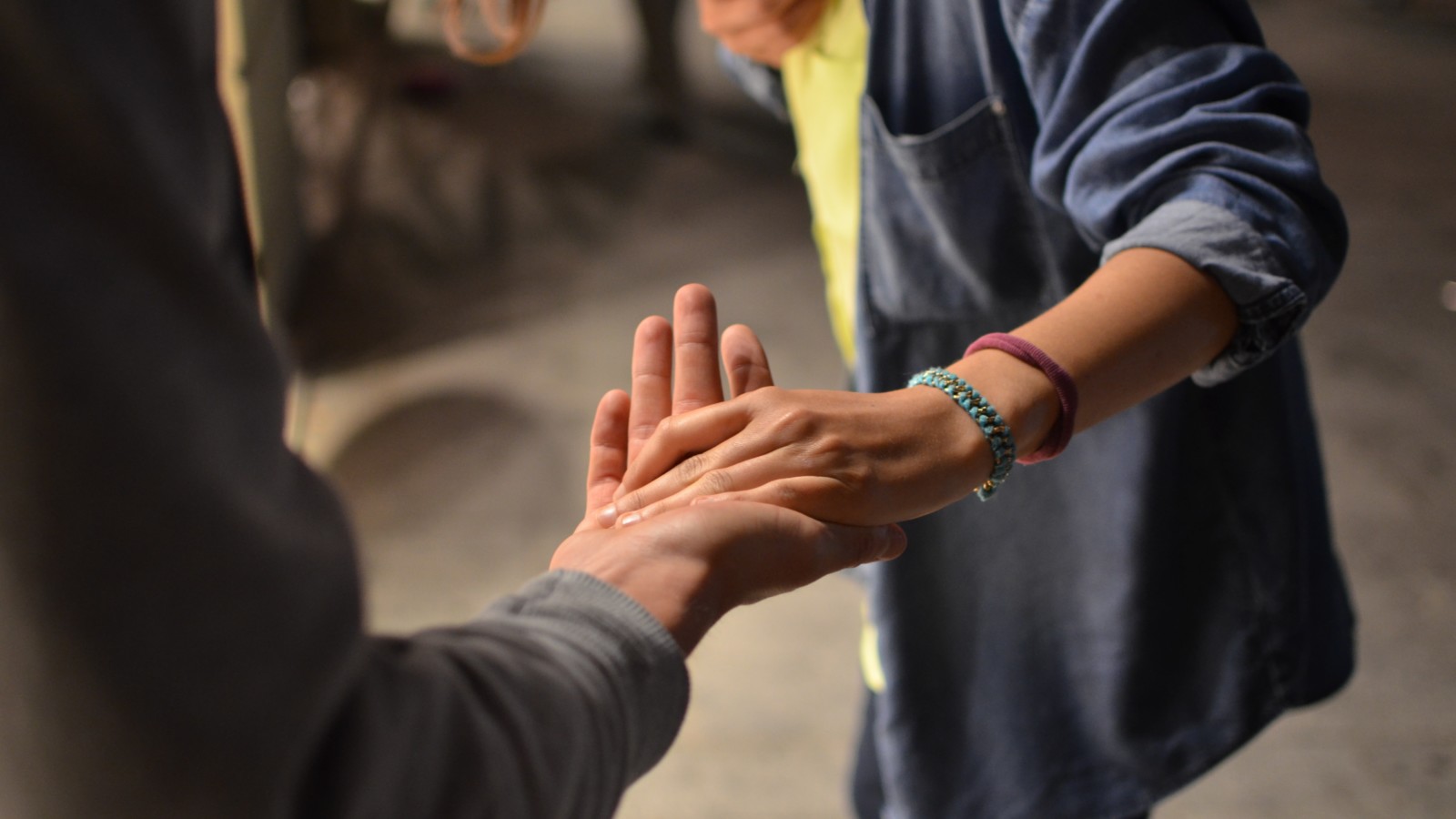 an image of people holding hands discussing the importance of mental health