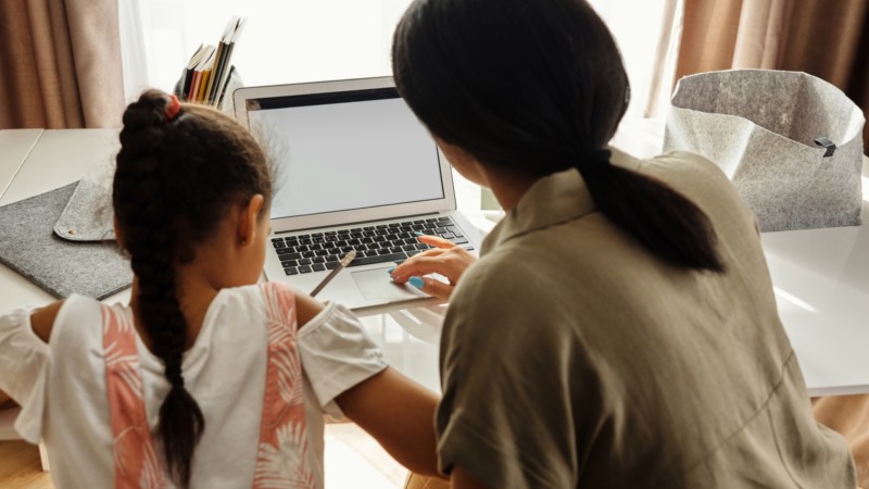 Mom Helping Child With Online Homework