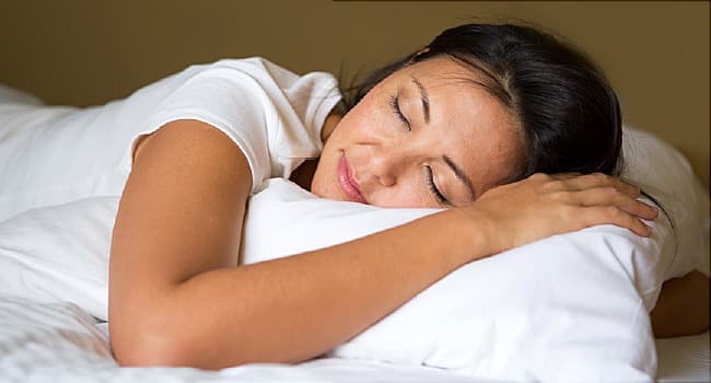 woman sleeping restfully on pillow