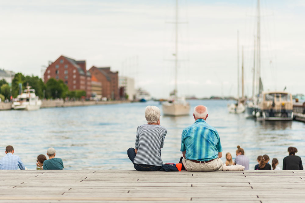 Elder couple taking in a view of the water in Copenhagen, Denmark. Image by © studiolaska