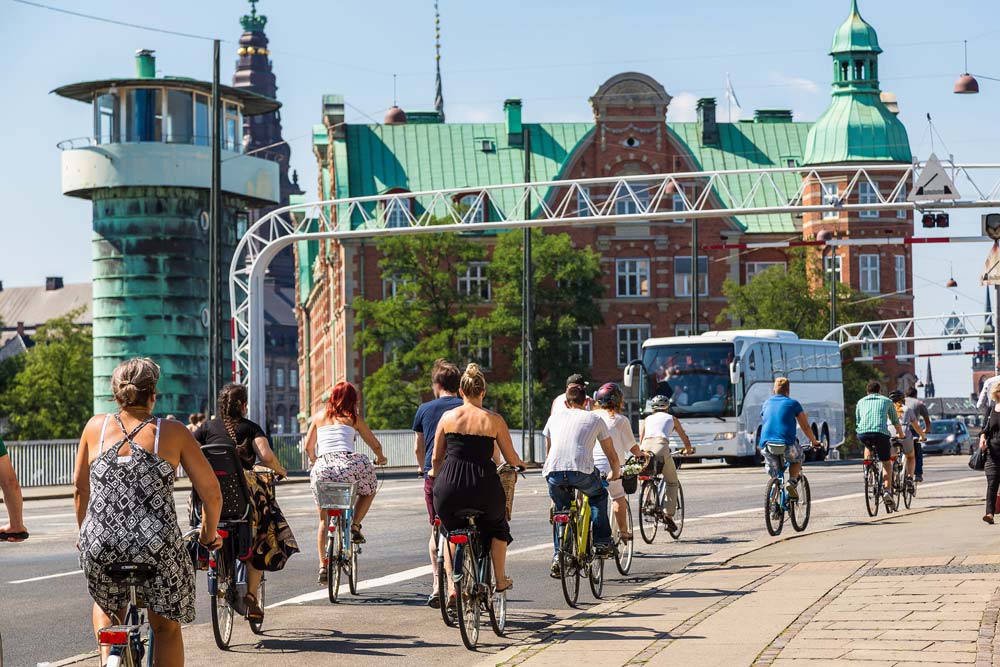 Everyone bikes in Denmark! Countless people commuting by bike in Copenhagen, Denmark. Image by © Sergii Figurnyi