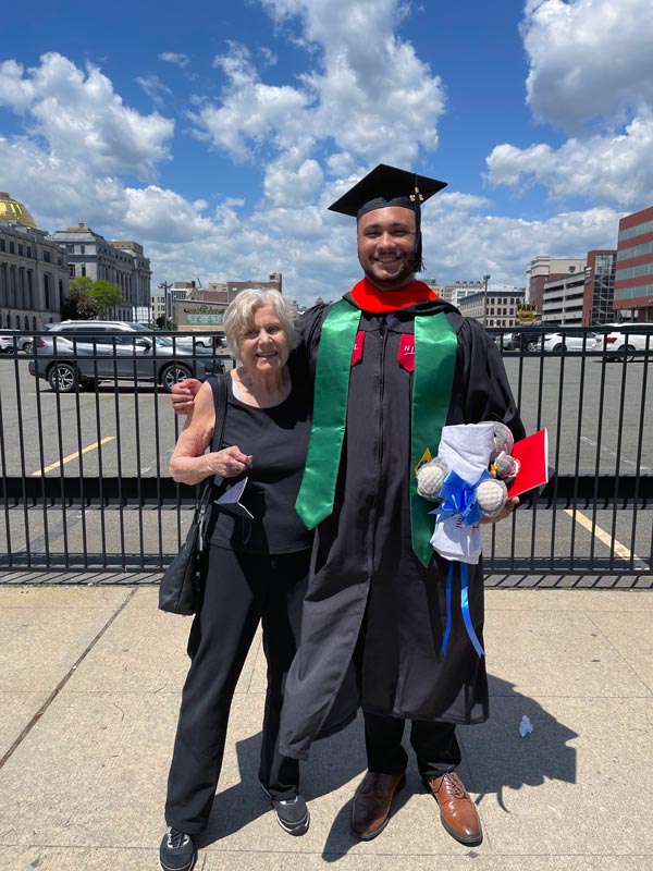 Personal picture of Katharine and her grandson Victor celebrating his college graduation.
