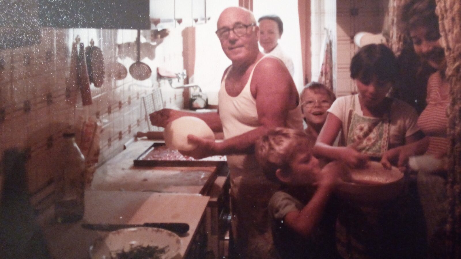 My Grandfather and I with family making pizza.