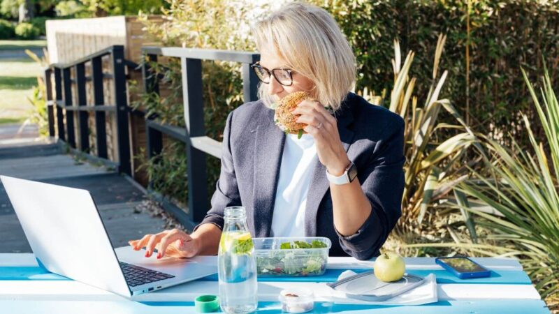 blonde entrepreneur working on computer trying to develop wellness habits to protect mental health
