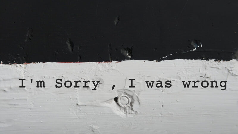 Black and white typewriter with words typed on paper "I am sorry, I was wrong".