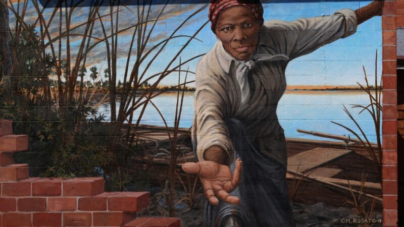 mural painting of a plantation worker with hand outstretched