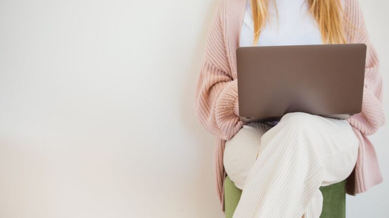 woman working on laptop to illustrate summer productivity tips from entrepreneurs