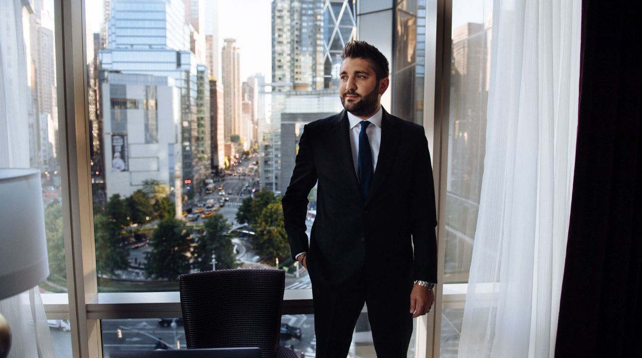 Liviu Tanase ZeroBounce CEO and founder pictured wearing suit with city landscape behind