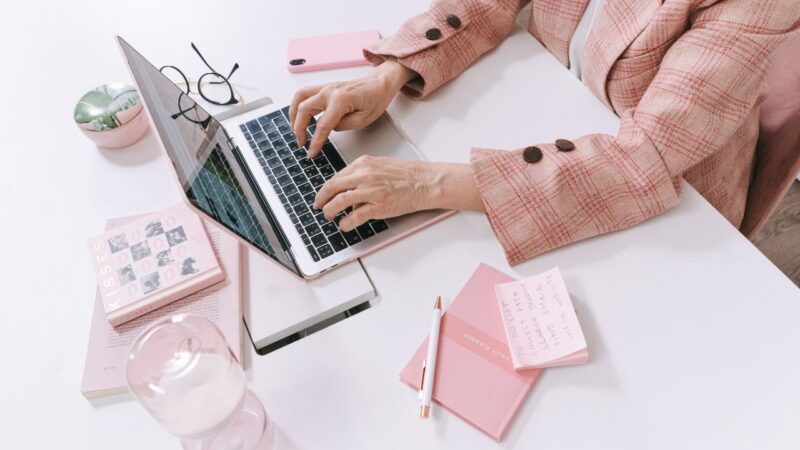 woman's hands showing typing on computer