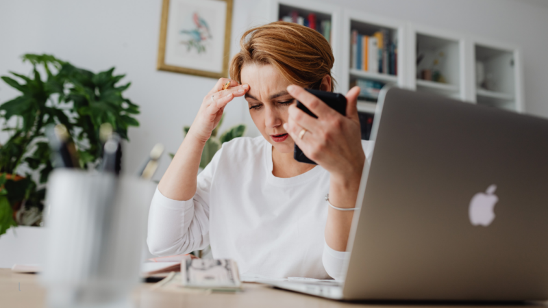 one woman alone at a desk, mid-thought